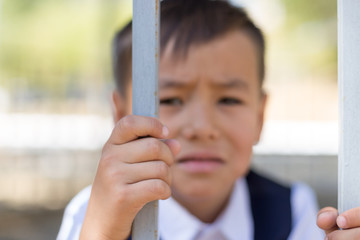 schoolboy holds cell and hopes for freedom or makes fun of the concept of life imprisonment