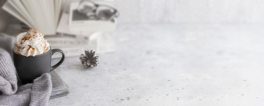 Mug of hot chocolate with milk cream and cinnamon. Winter relax beverage for  hygge  mood. Large background for banner.