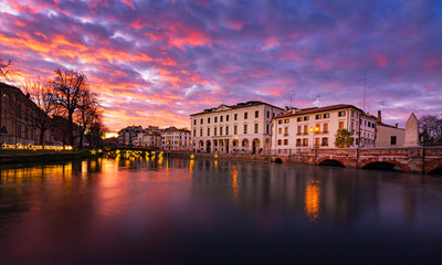Fototapeta na wymiar 27 december 2019 (Treviso, Italy): Landscape of the University building in Treviso and the river Sile at sunset on Christmas time
