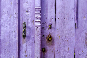 old purple wooden door with lock
