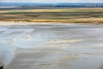 Low tide in the bay in front of Mont Saint Michel in Normandy, France.
