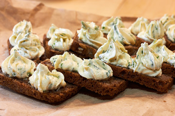 Homemade appetizing rye bread sandwiches with soft cheese cream