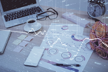 Financial chart drawing and table with computer on background. Double exposure. Concept of international markets.