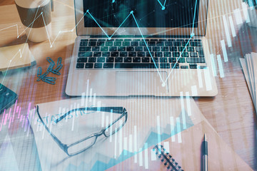 Double exposure of forex chart and work space with computer. Concept of international online trading.