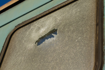 Vandalism on the railway. Vandalism concept. Train vandalism. Broken windows of blue old rusty train. Broken train compartments. Abandoned train window detail.