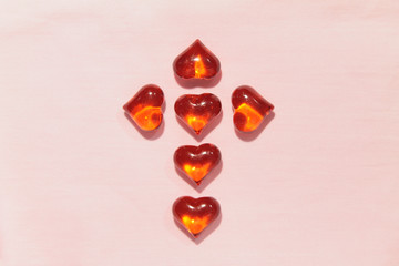 Cross of red hearts on a pink background. stock photo for valentine's day. For web, print,...