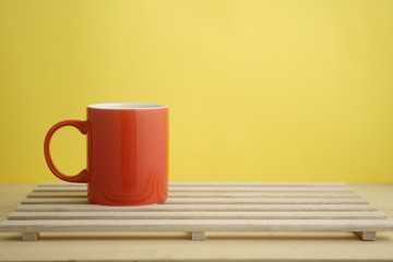 an empty pastel color mug on wooden base