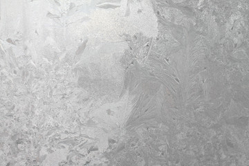 Frosty pattern on glass. Abstract gray background. Crystal faceted texture  Stock photo for web and print.