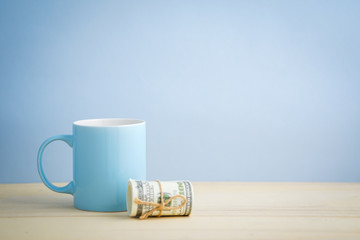 an empty pastel color mug with flower and retro clock