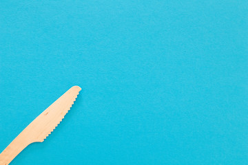 Knife Cutlery on a bright blue background. Eco-friendly wooden disposable cutlery on bright colored...