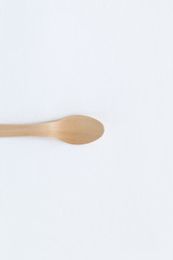 Spoon Cutlery on a bright white background. Eco-friendly wooden disposable cutlery on bright colored backdrop. Wallpapers for modern and ecological food. Plastic Free background for food banner