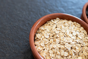 bowl of oats for a healthy vegan breakfast. Breakfast with cereals for beauty and well-being. Oat flakes in a rustic bowl