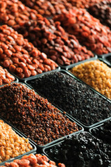 Dried berries on the counter. Raisins, dried apricots, prunes. Vegan food