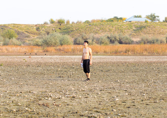 a young man walks in dirty, salty ecological places