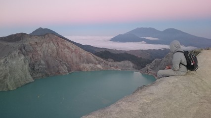 Beautiful sunrise, purple sky, on top of the crater mount Ijen
