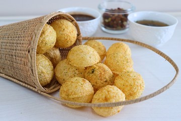 Panipuri or Golgappa. Indian street snack made of fried mint flavors puries, mint chutney, sprouts and dates, tamarind chutney. Indian Chat.