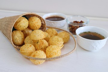 Panipuri or Golgappa. Indian street snack made of fried mint flavors puries, mint chutney, sprouts and dates, tamarind chutney. Indian Chat.