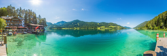 Panoramic picture over Weissensee lake in Austria with turquoise water from view point Ronacher Fels in summer