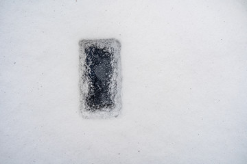 frozen smart phone in snow