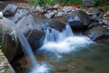 Closeup view of little waterfall flowing rapid on the river