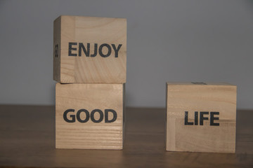 Enjoy good life, positive inspirational messages on wooden cubes