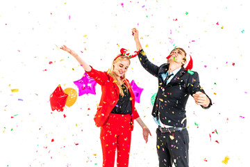 Fototapeta na wymiar young couple enjoy dance with colorful confetti in new year celebration party