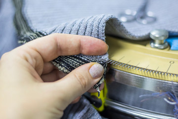 impaling on needles of details for their connection on the special machine of knitted production