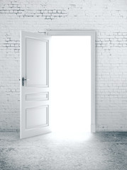 Open door in white brick wall