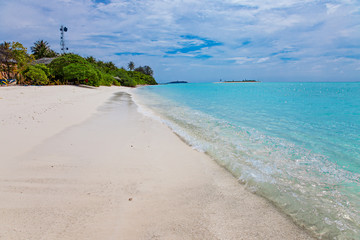 Turquoise blue sea water shore and cloudy sky