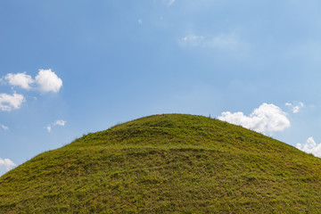 Ideal green round hill and blue sky with clouds above it. Krakus Mound, Krakow, Poland. - obrazy, fototapety, plakaty