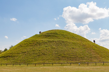 Ideal green round hill and blue sky with clouds above it. Krakus Mound, Krakow, Poland. - obrazy, fototapety, plakaty