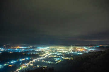 Naklejka premium View of the night Ukrainian city in the fog