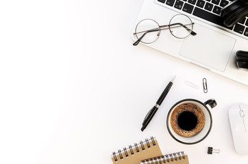 Flat lay programmer's workplace white table with silver laptop and coffee cup. Top view International Programmers' Day concept with pen, spiral notebook and copy space for your text