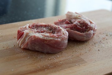 Two pieces of raw meat on a wooden board. Spiceless Beef