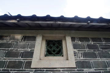 Tiles of old residential houses in South China and old walls made of stones