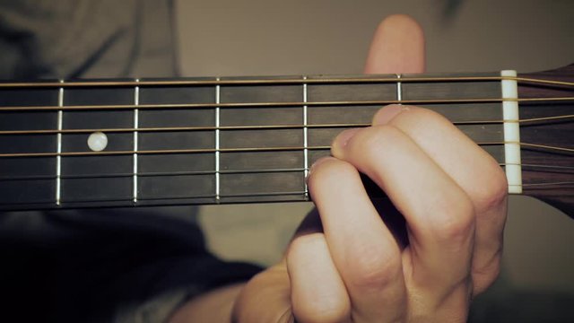 Arrangement of an A-Chord on the Guitar. Male hand shaping an A Chord on the fretboard.