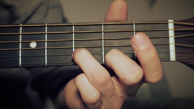 Arrangement of The D-Chord on the Guitar. Male Hand Shaping an A Chord on the Fretboard.