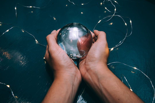 Hands Holding Glowing Crystal Ball For Future Fortune Teller