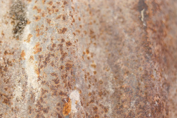 Old rusty zinc sheet with rough and spotted surface with selective focus