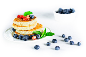 Pancake with berry and mint. White background.