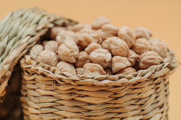 Healthy organic dried chickpeas in a straw basket