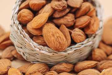 Healthy organic dried almonds in a straw basket