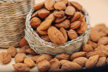 Healthy organic dried almonds in a straw basket