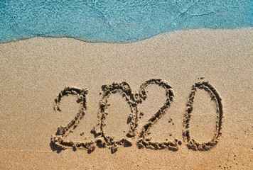The symbols 2020 written on sand.