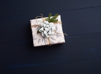 gift wrapped in colored paper on a blue wooden background