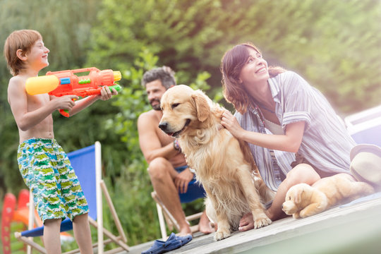 Tilt shot of family with Golden retriever dog on pier