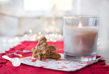 Christmas cookies and candle on table
