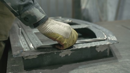 Forge workshop on table. Smithy manual production. Work on the product. Ruler, angle grinder. The blacksmith makes iron products for manufacture of fireplaces, stoves.