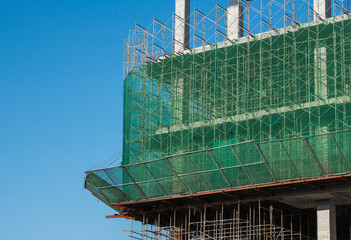 Building and Construction Site in progress. Building construction site against blue sky. Metal...