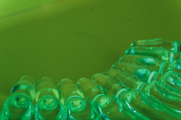 Glass medical ampoule vial for injection. Medicine is liquid sodium chloride with of aqueous solution in ampulla. Close up. Bottles ampule multicolor on background color and water. Human plasma.